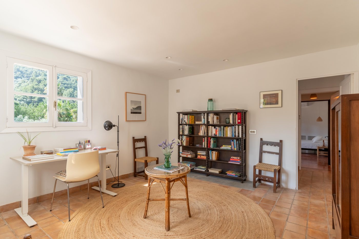 The library desk by the window, set up for work