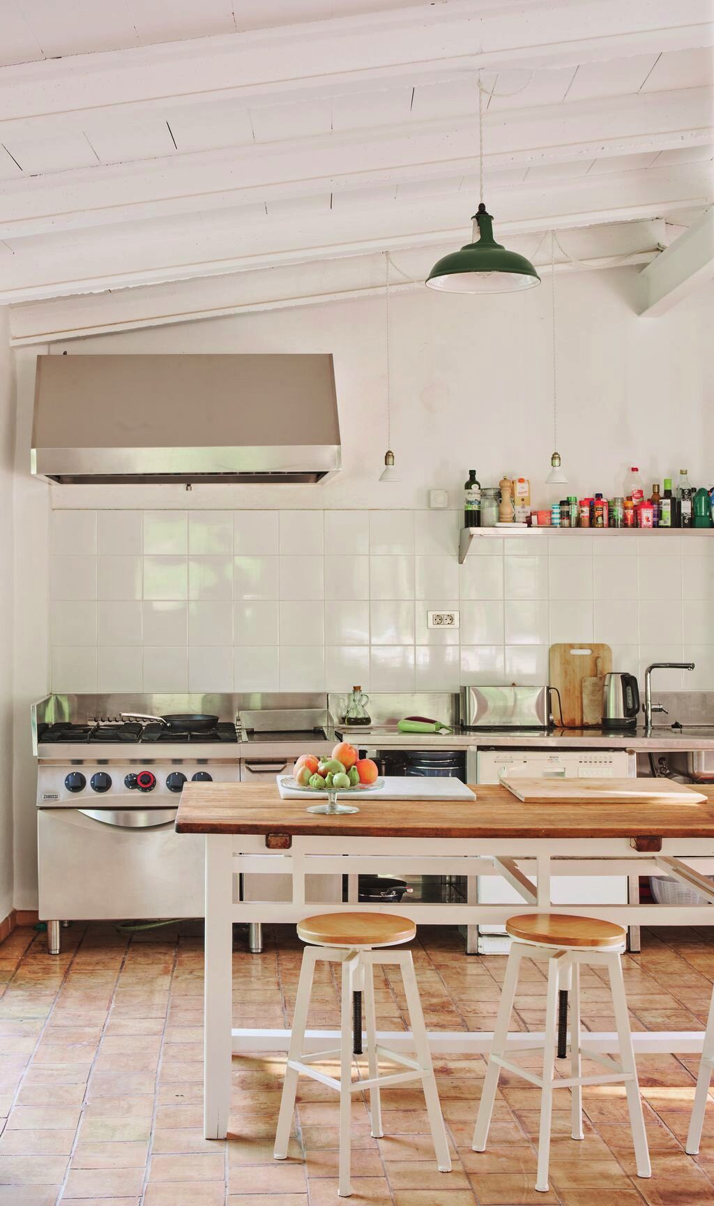 Kitchen with an island, wooden stools and open shelving