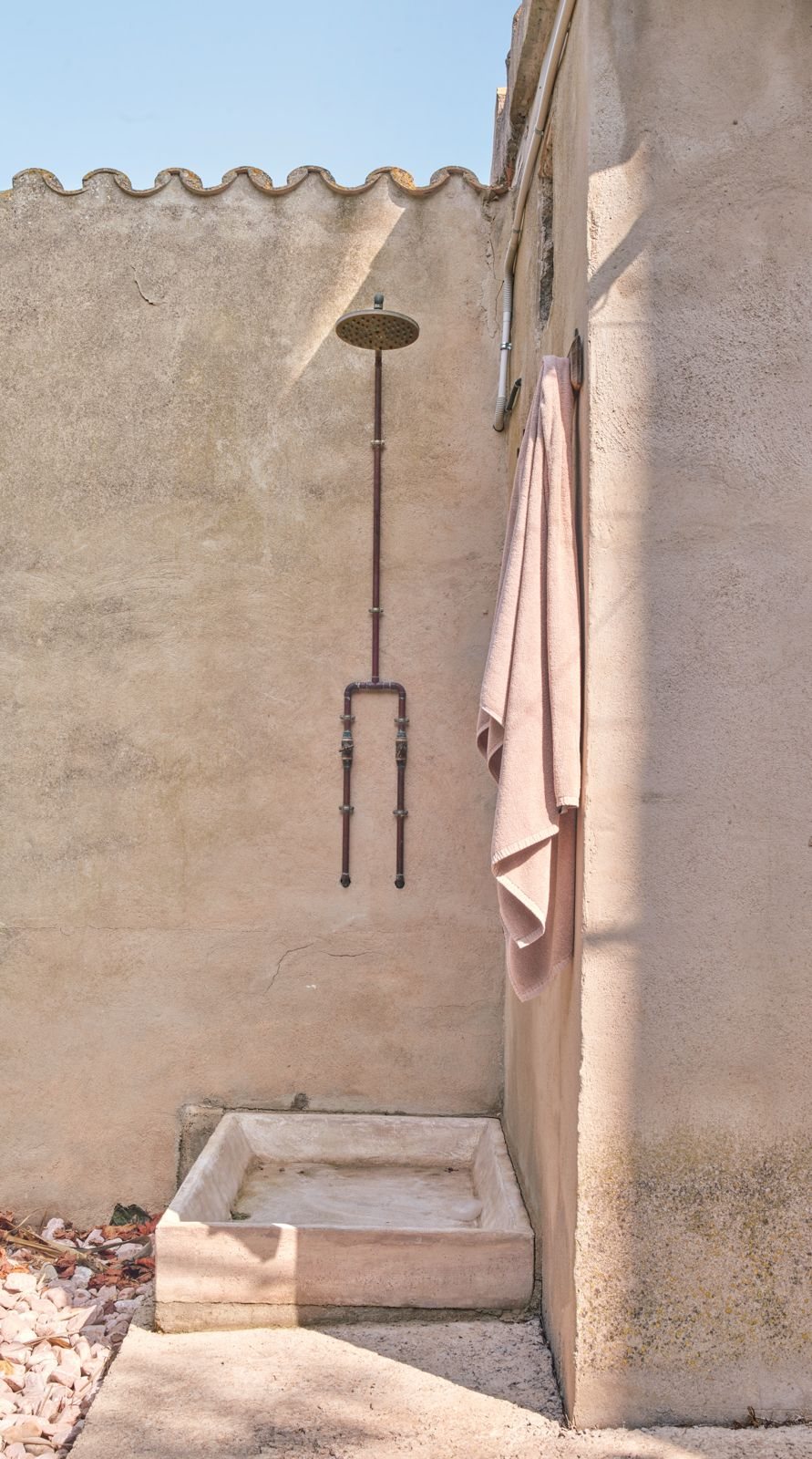 Outdoor shower by the whitewashed wall