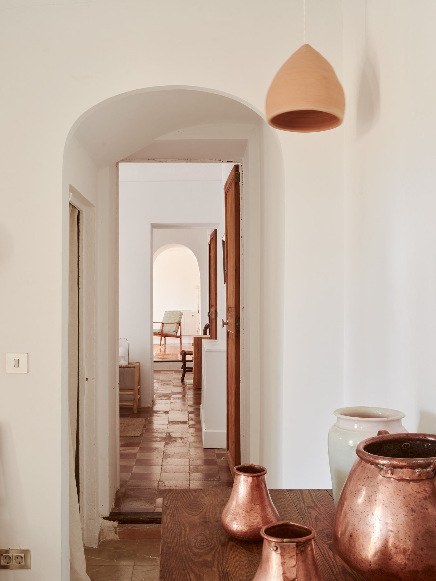 Hallway with arches and copperware