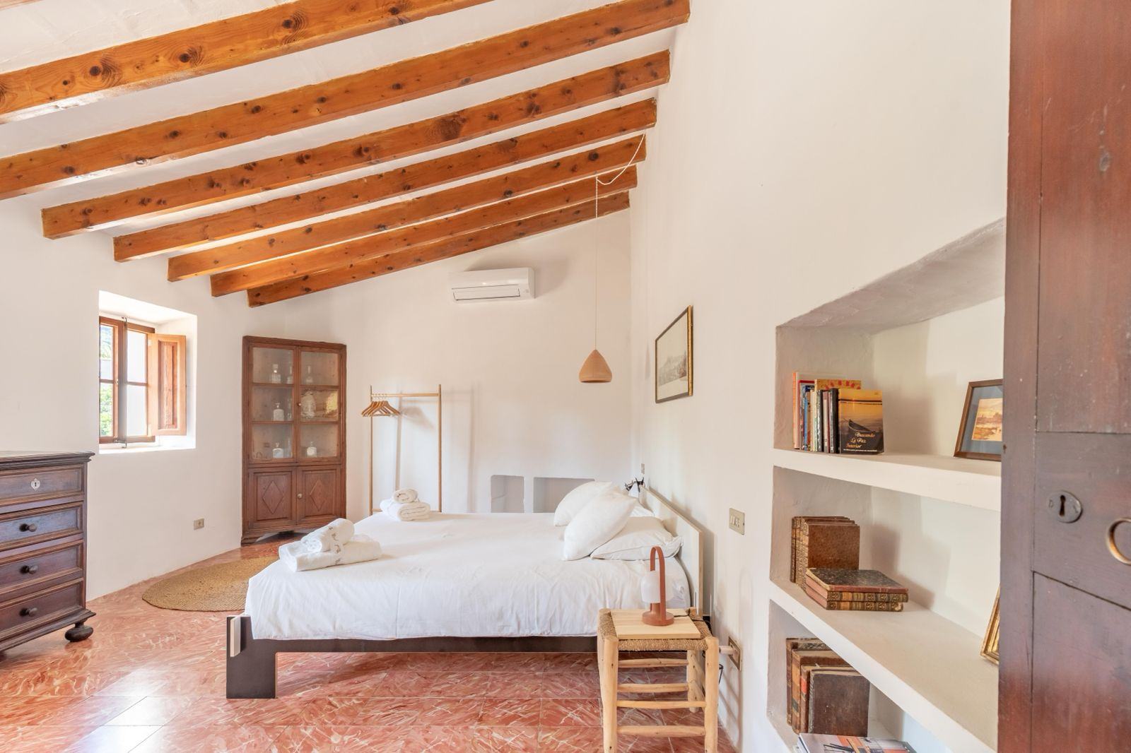 Roja bedroom, with a king-size bed and built-in bookcase