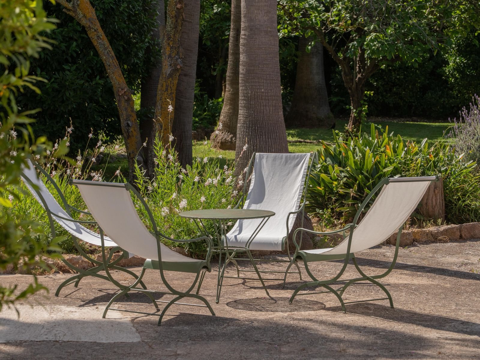 Chairs in the shade in the garden · Finca Sa Sinia